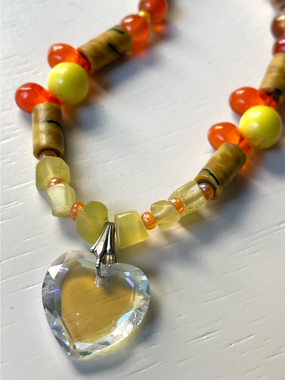 Vintage colorful beaded necklace w/ crystal (?) heart glows boho yellow orange